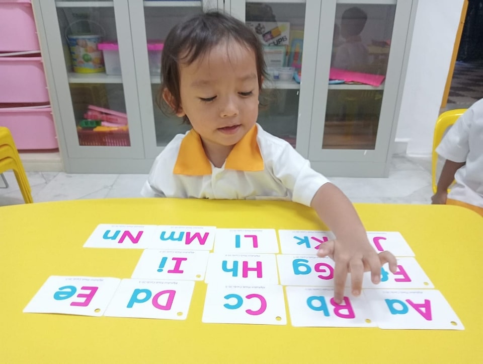 A young child engaged in creative play at LEO Preschool